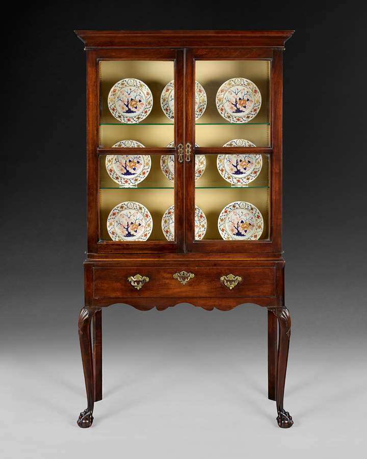 A GEORGE II MAHOGANY CABINET ON STAND